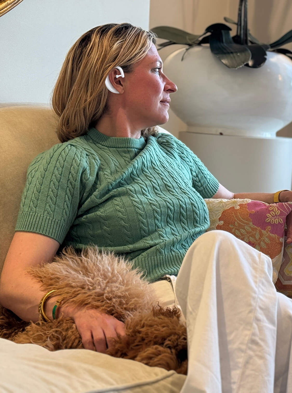 Woman with dog in sitting room wearing Sona